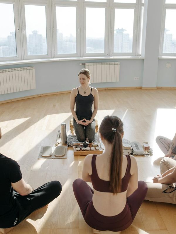 A diverse group of people sitting in a calm meditation circle.